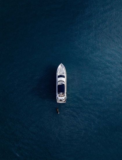 aerial view on boat on open dark blue ocean Deep Bay Marina