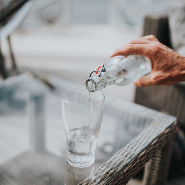 Man pouring water at table