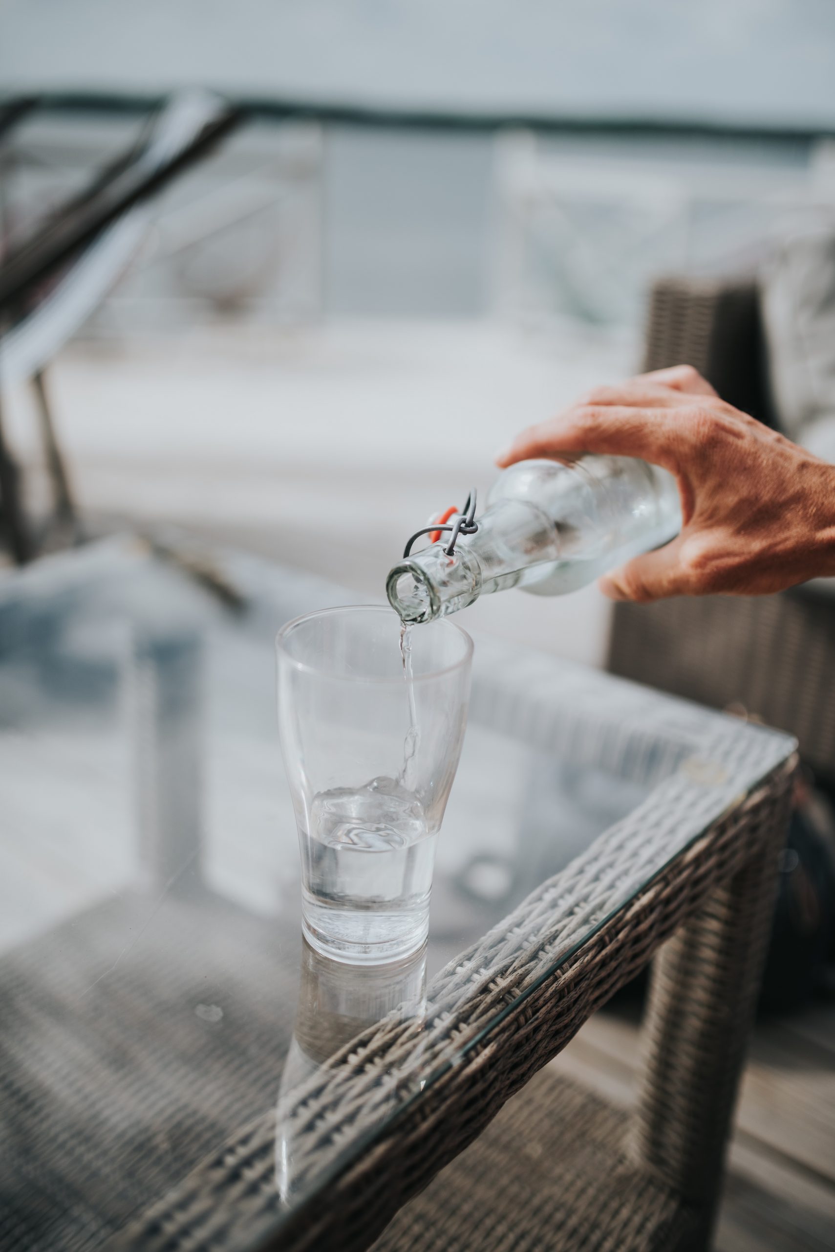 Man pouring water at table